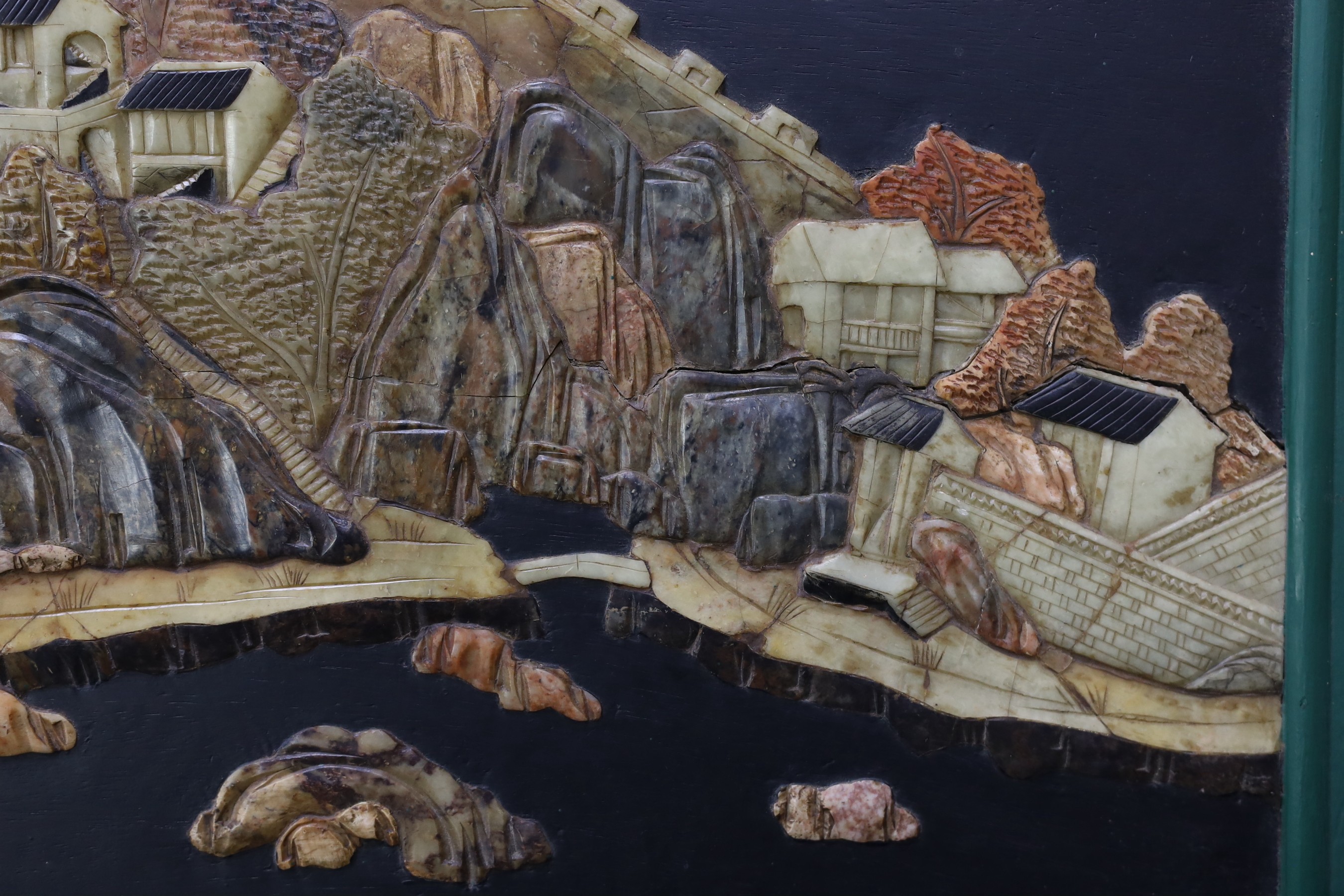 A pair of Chinese soapstone overlaid landscape panels, early 20th century, each panel including frame 33.5cm x 59cm